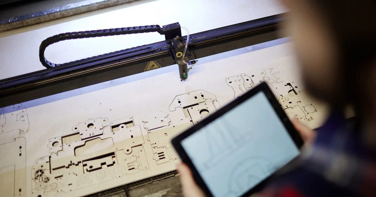Laser cutter guided by tablet producing precise shapes in wood